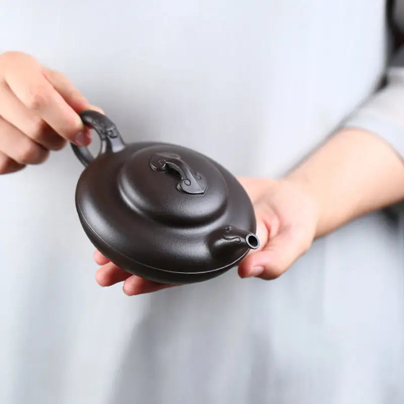 Dark round Yixing Zisha teapot from Eclipse collection for traditional tea brewing