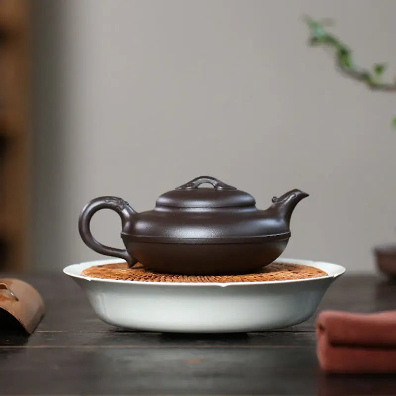 Brown ceramic Yixing Zisha teapot Eclipse for traditional tea brewing