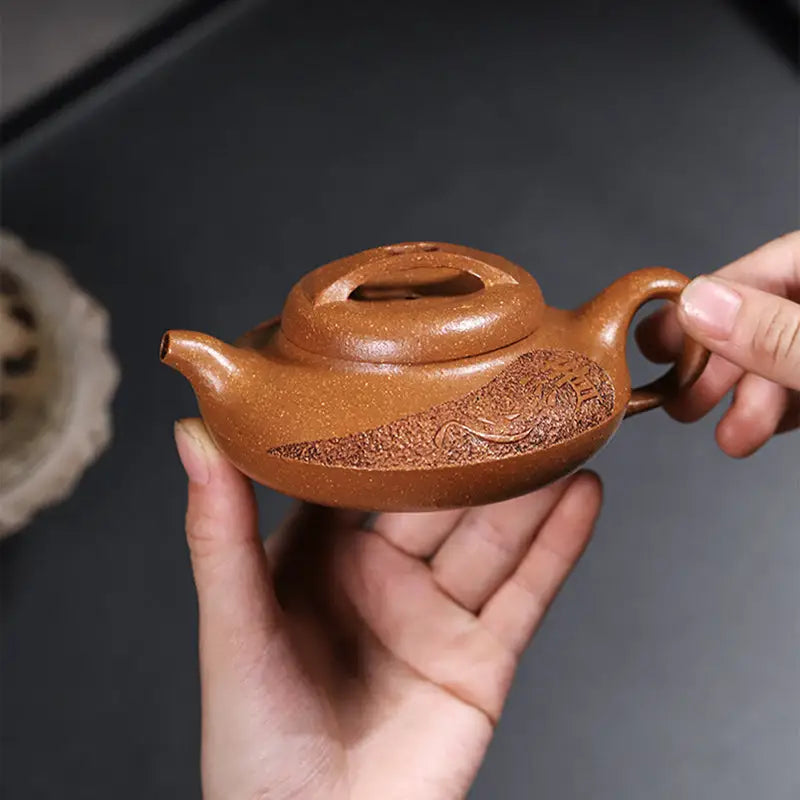 Brown clay Yixing Zisha teapot with carved design from the Elegance handcrafted Yixing collection