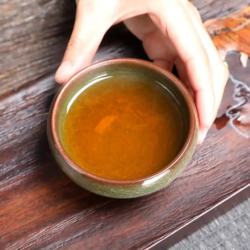 Emerald Jian Zhan ceramic teacup with crystalline green glaze and amber liquid, 130ml ceremonial vessel