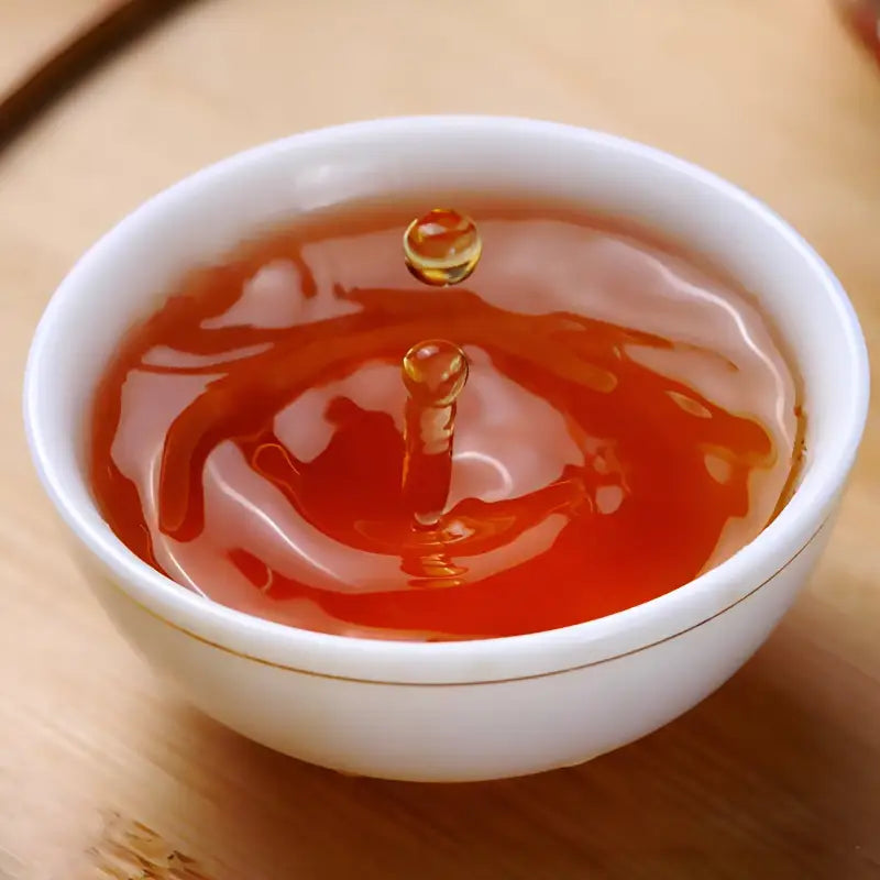 Honey in a white bowl with Floral Sou Chong Red Tea Leaves, perfect for tea sets and mugs