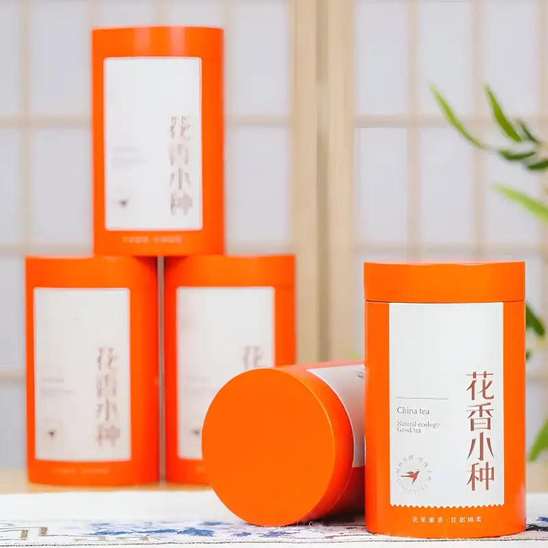 Orange cylindrical tea containers for Floral Sou Chong Red Tea Leaves with teapots and mugs