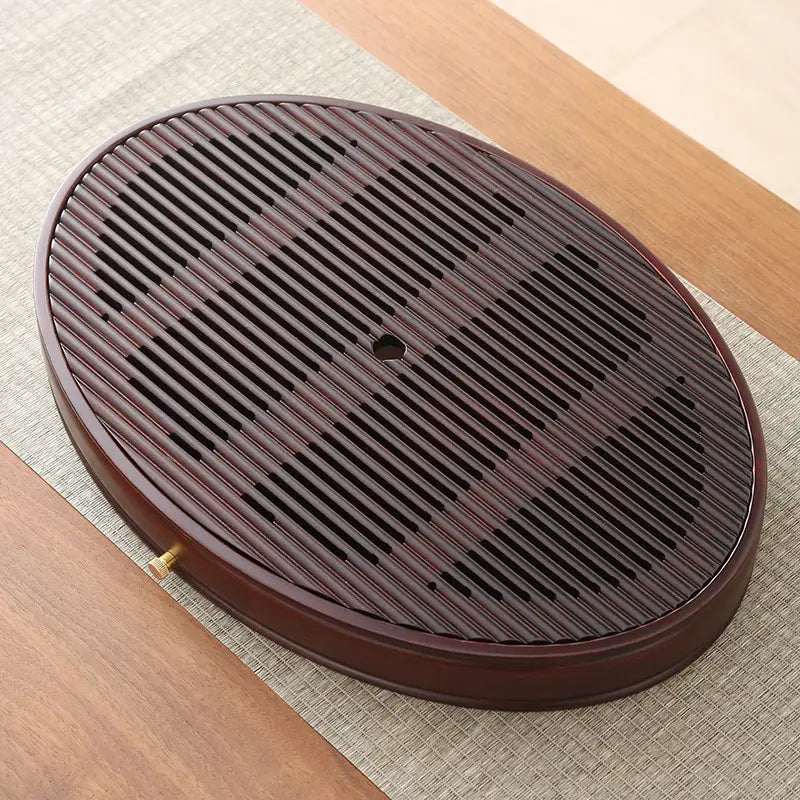 Oval slatted dark-wood tea tray from Flowing Zen bamboo tea tray collection
