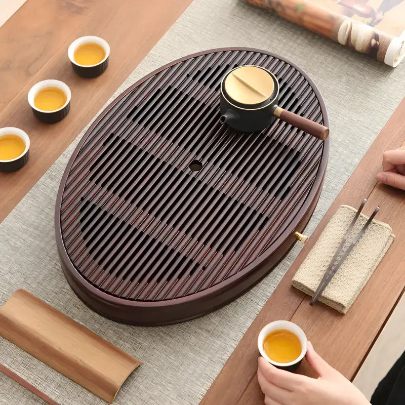 Oval wooden tea tray with drainage slats for flowing zen bamboo tea tray display