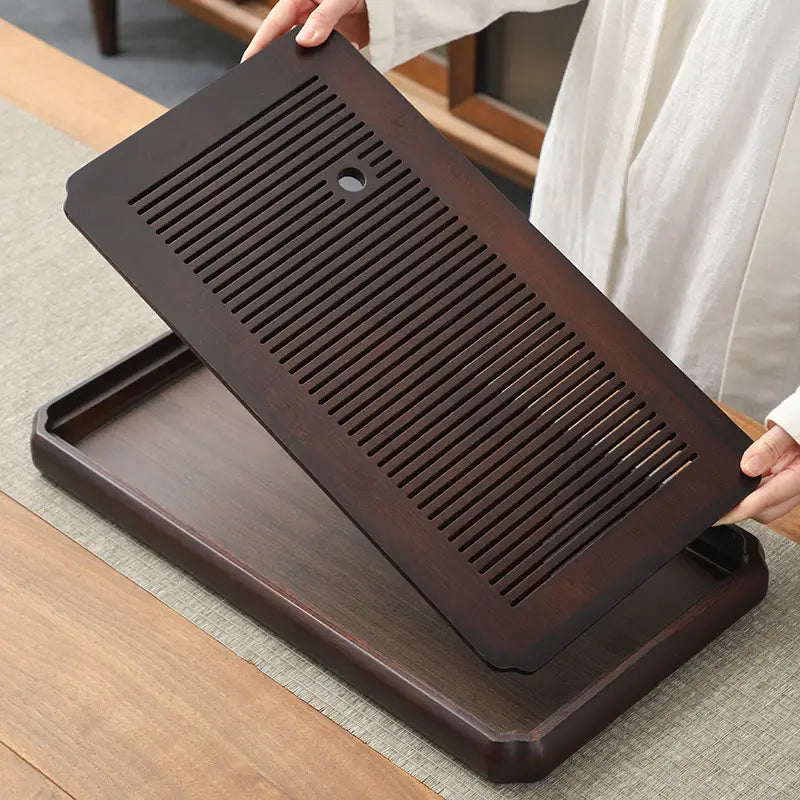 Dark wooden tea tray with slotted top for Gongfu Tea and bamboo Gongfu brewing