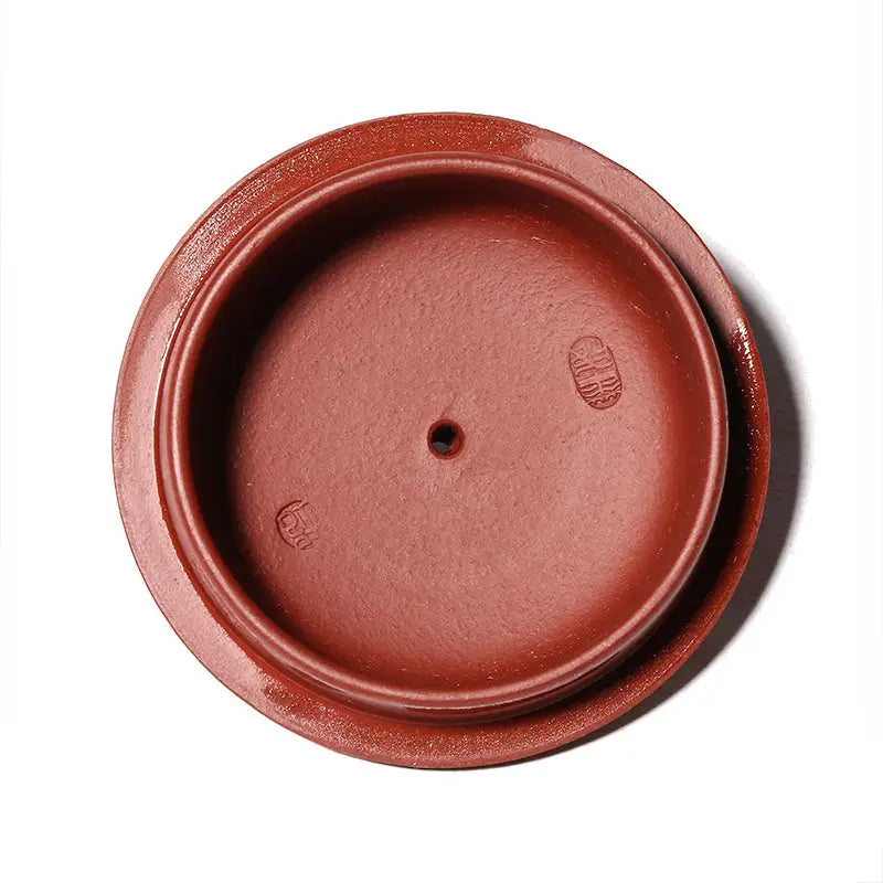 Round reddish-brown Yixing Zisha ceramic lid with central hole and hand-carved dragon design in Imperial Ascend Yixing