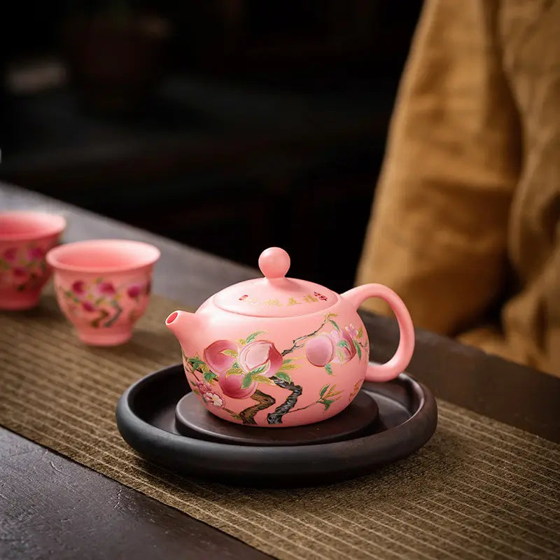 Pink teapot with peach design from Forest Echo Yixing Zisha Zisha Clay Tea Set