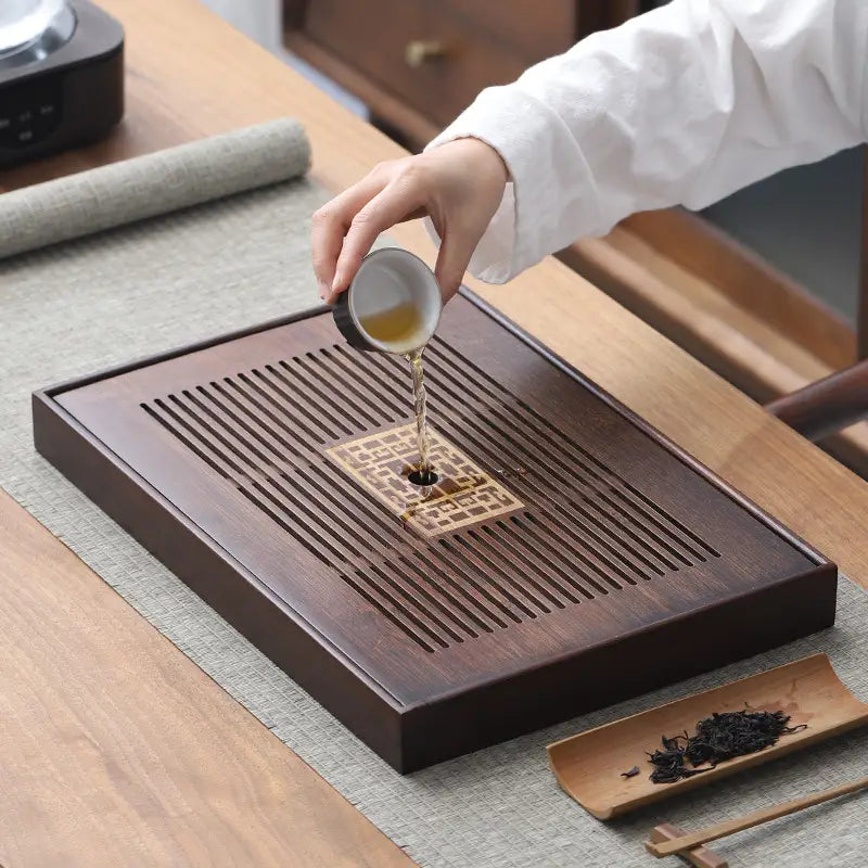 Dark wooden bamboo Gongfu tea tray with drainage for traditional tea brewing