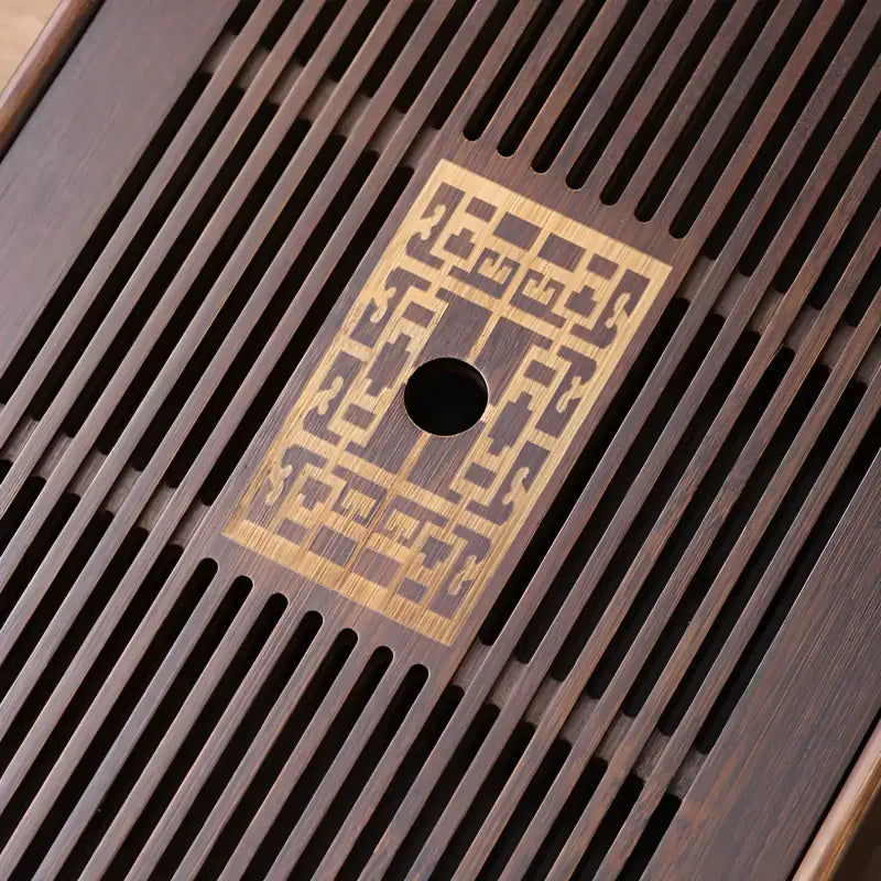 Dark wooden Gongfu tea tray with decorative bamboo center for traditional tea serving