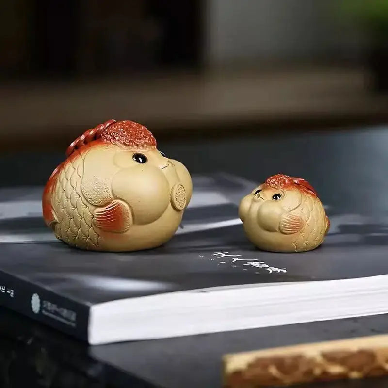 Two clay goldfish figurines, feng shui tea pets from the Fortune Bloat Yixing clay tea pet collection
