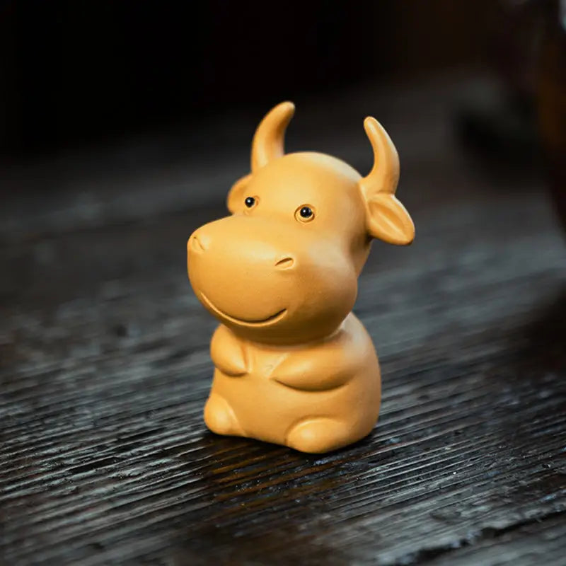 Smiling ceramic ox figurine Fortune Grazer tea pet guide Feng Shui tips for prosperity