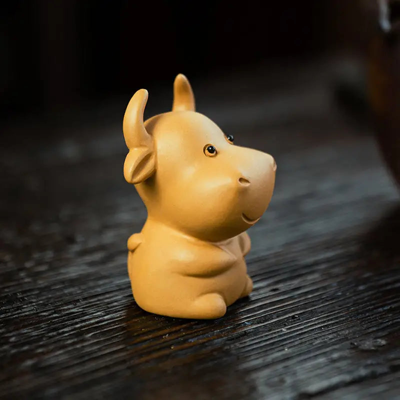 Cute ceramic ox figurine from Fortune Grazer tea pet guide for feng shui tips