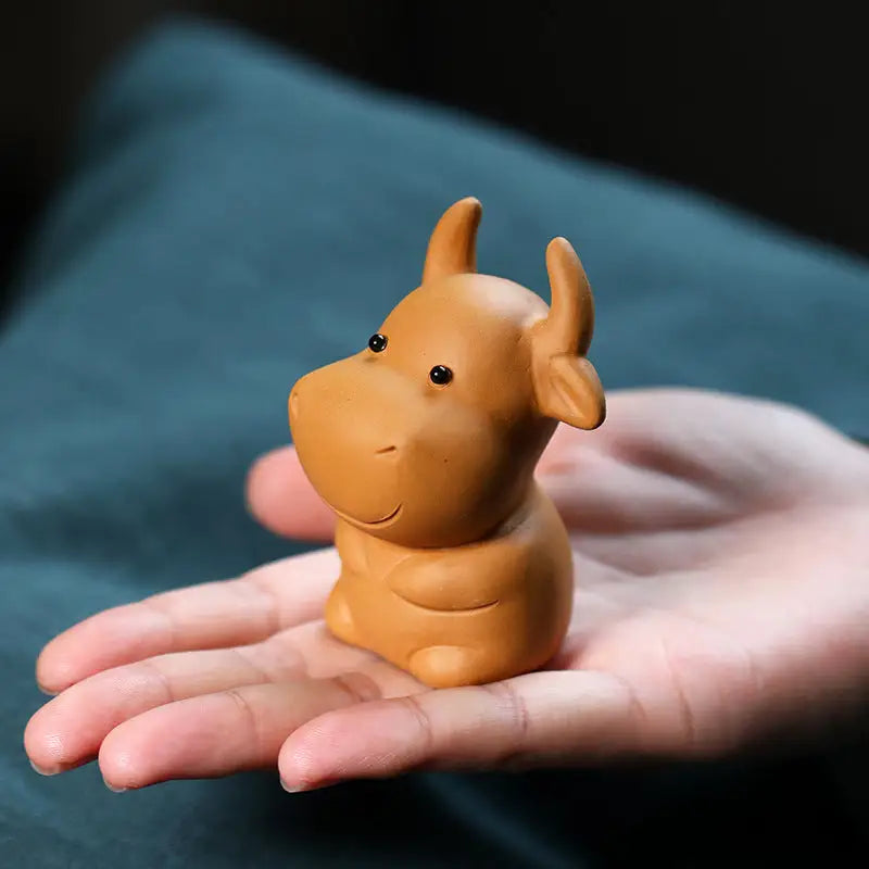 Brown ceramic cow figurine Fortune Grazer tea pet guide feng shui tips for positive energy