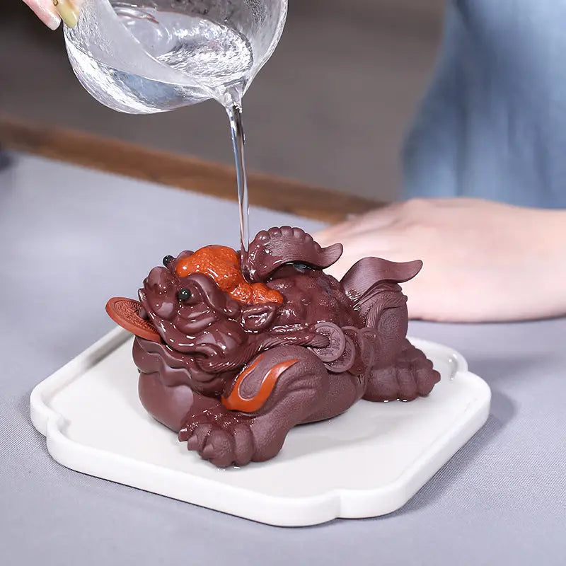 Brown ceramic money frog as part of Fortune Guardian Pixiu pixiu tea pet collection