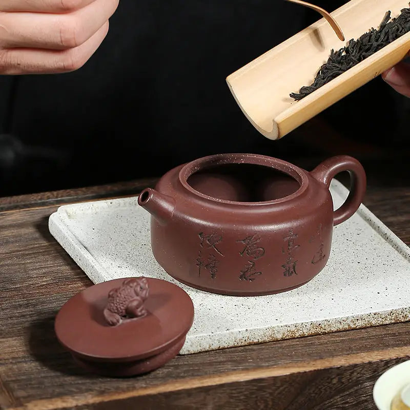 Brown ceramic Fortune Toad Yixing teapot with frog-shaped lid, perfect for Yixing Zisha collectors