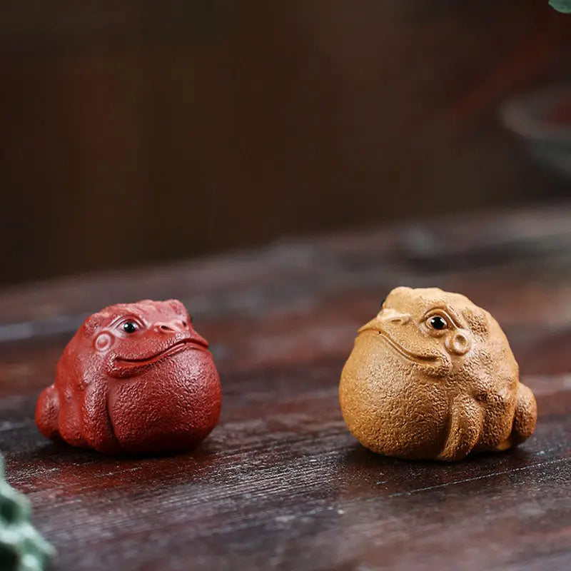 Ceramic frog figurines from Fortune Warden Toad, perfect tea pet guide for Yixing Zisha tea lovers