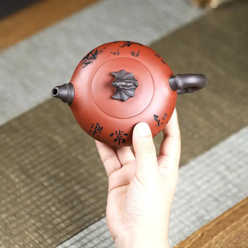 Round reddish-brown Yixing Zisha teapot with frog lid sculpture and authentic craftsmanship