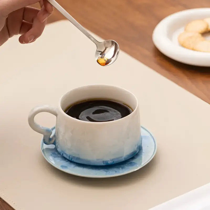 Ceramic Frosted Dawn Coffee Cup with tenmoku glaze, matching saucer, and honey spoon