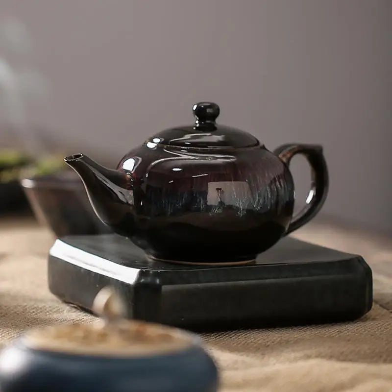 Dark glossy ceramic teapot with tenmoku glaze resembling a night sky, Galaxy Teapot