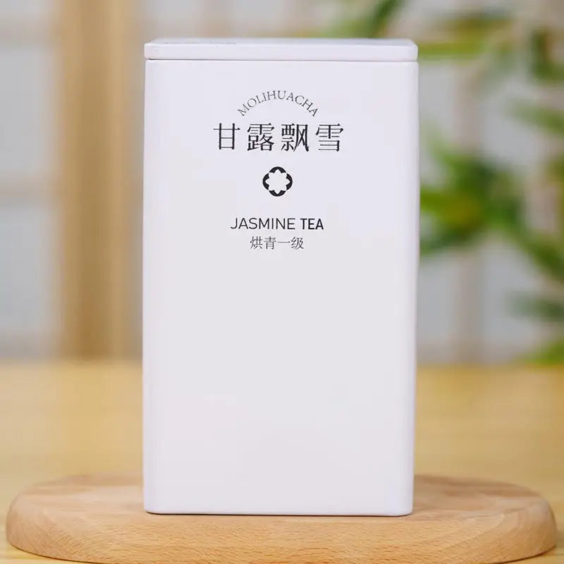 White jasmine tea container from Gan Lu Piao Xue Jasmine Tea Leaves with elegant teapots