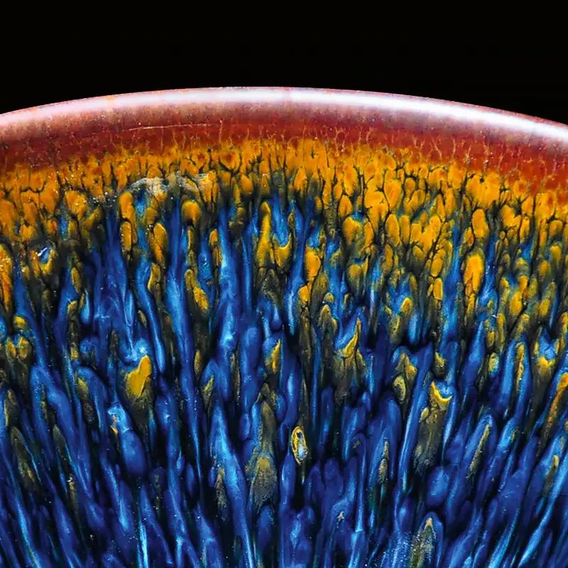 Ceramic glaze with blue and gold streaks on handcrafted Jianyang Tenmoku Gongfu Tea Cup Geocentric