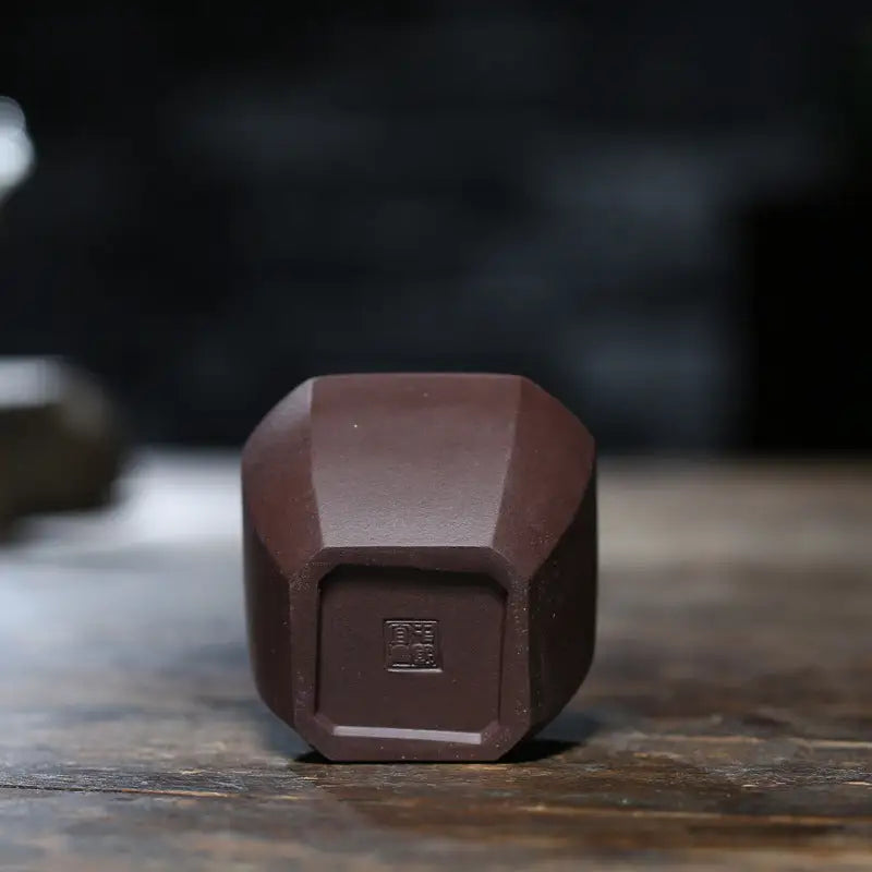 Polygonal brown ceramic zisha clay teacup from Geometric Tranquility, ideal for gongfu tea