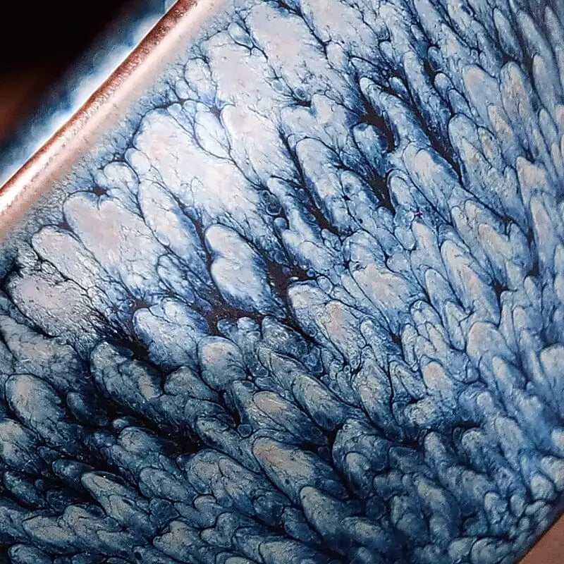 Blue and white glazed ceramic tea bowl from Glacier Jian Zhan showcasing tenmoku style