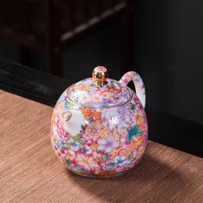 Floral enamel teapot with gold accents showcasing Jingdezhen enamel art in Gold Floral Enamel Teapot