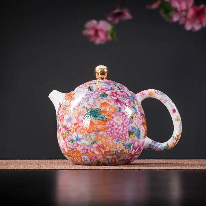 Floral enamel teapot with gold floral enamel design showcasing Jingdezhen enamel art