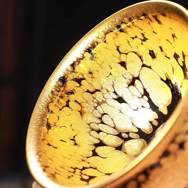 Radiant golden Jian Zhan teacup with speckled design for gongfu tea brewing