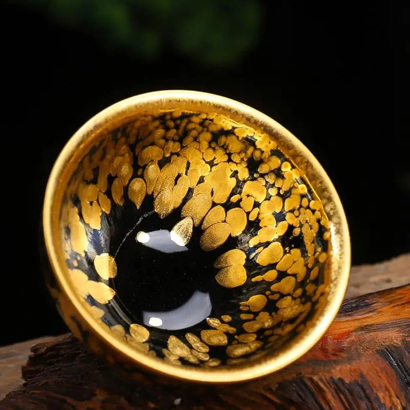 Black and gold speckled Jian Zhan teacup with radiant golden finish for gongfu tea