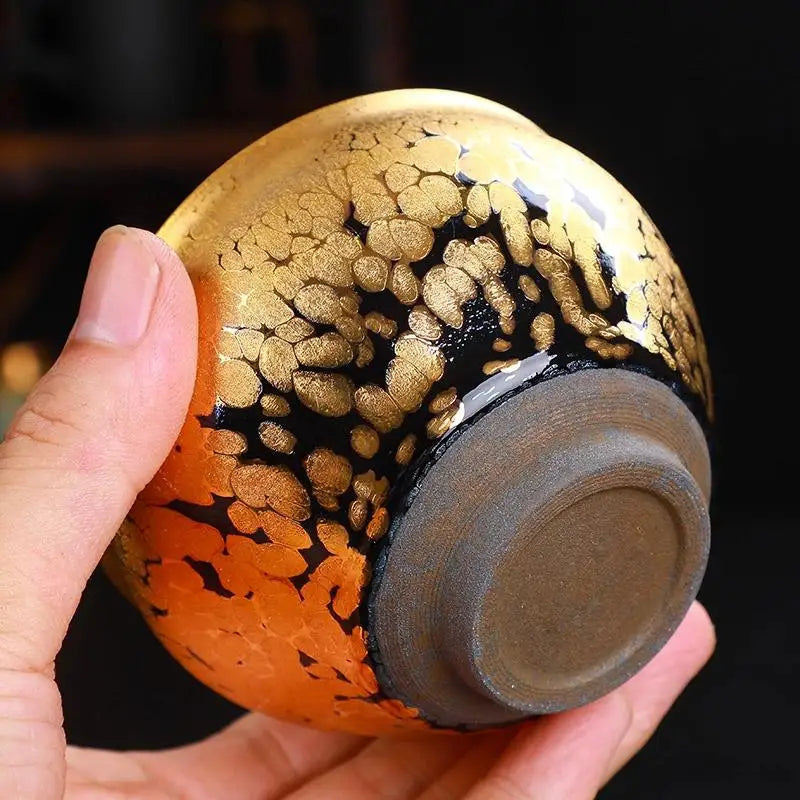 Gold-speckled ceramic Jian Zhan teacup with radiant golden finish for gongfu tea brewing