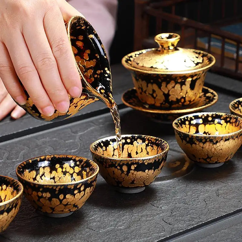Black and gold tea set including a Fairness Pitcher for Jian Zhan Tea enthusiasts