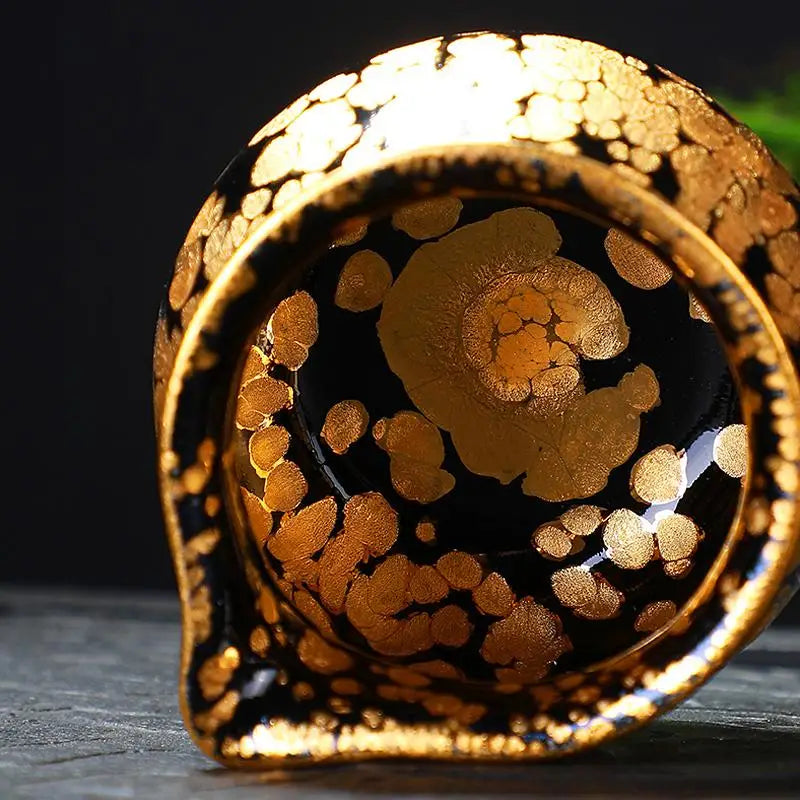 Black and gold patterned ceramic fairness pitcher from Gold Tea Set, ideal for Jian Zhan tea