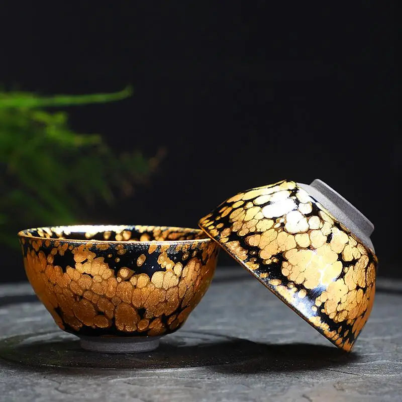 Gold-patterned teacups from Gold Tea Set, perfect for Jian Zhan Tea and fairness pitcher rituals