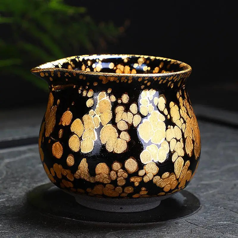 Black and gold speckled ceramic fairness pitcher from the Gold Jian Zhan Tea Set