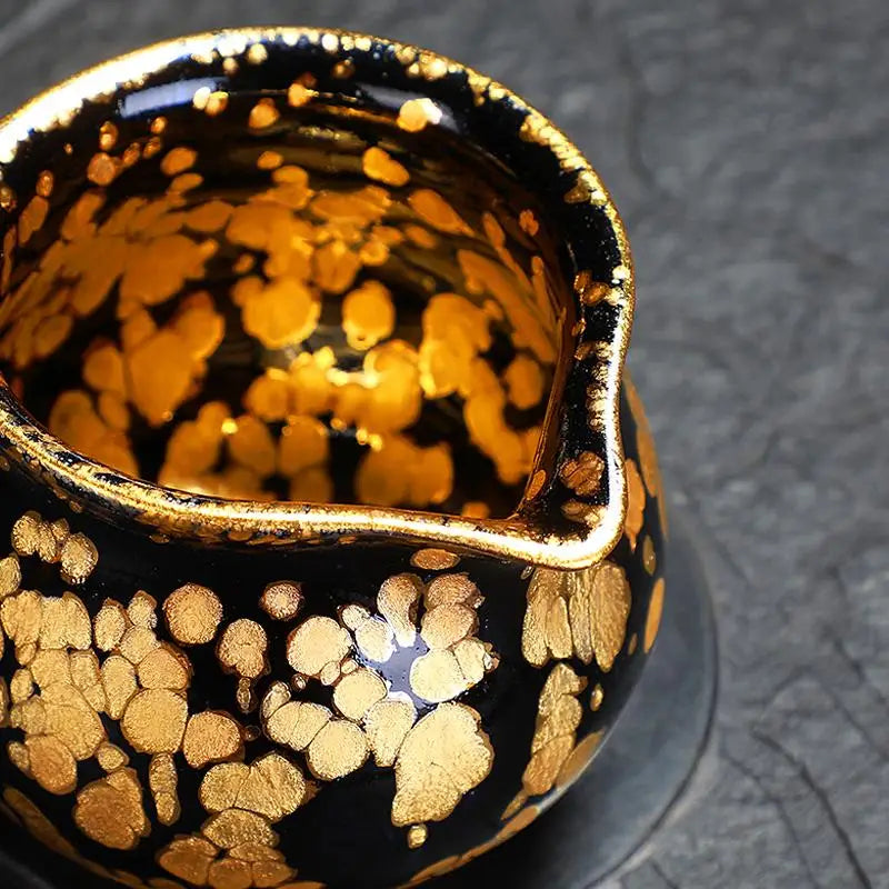 Black and gold speckled ceramic fairness pitcher from Gold Tea Set, perfect for Jian Zhan tea