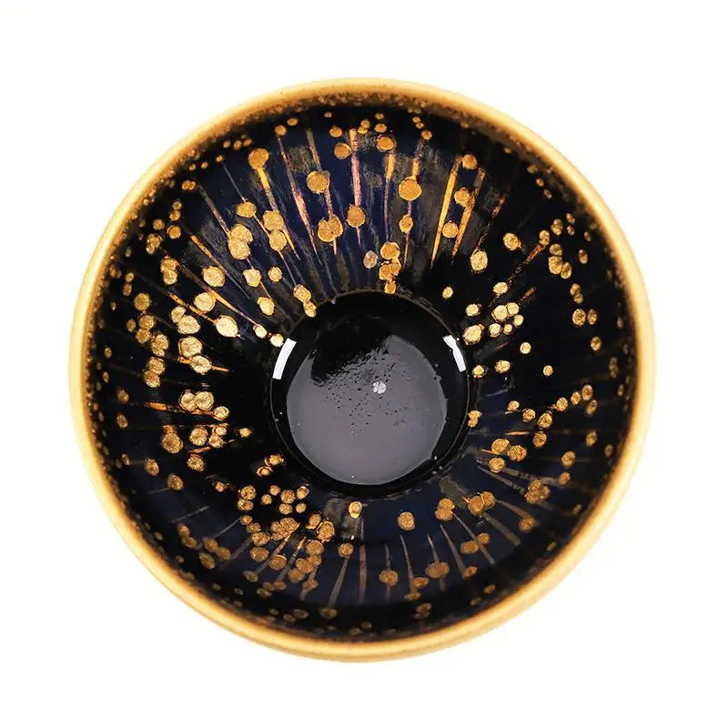 Dark blue ceramic bowl with gold speckles from Golden Drops, perfect for Jian Zhan tea connoisseurs