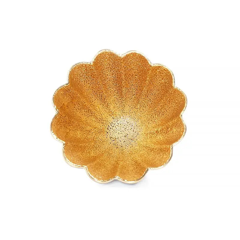 Golden flower teacup in gold-colored, flower-shaped bowl for elegant tea service
