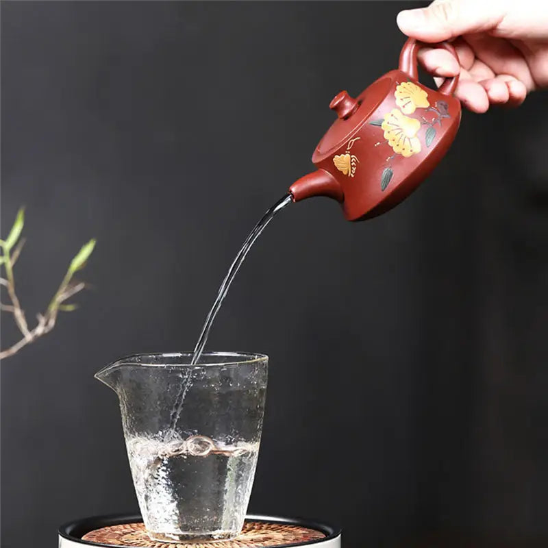 Brown Yixing Zisha Teapot pouring water in Golden Ginkgo harmony design
