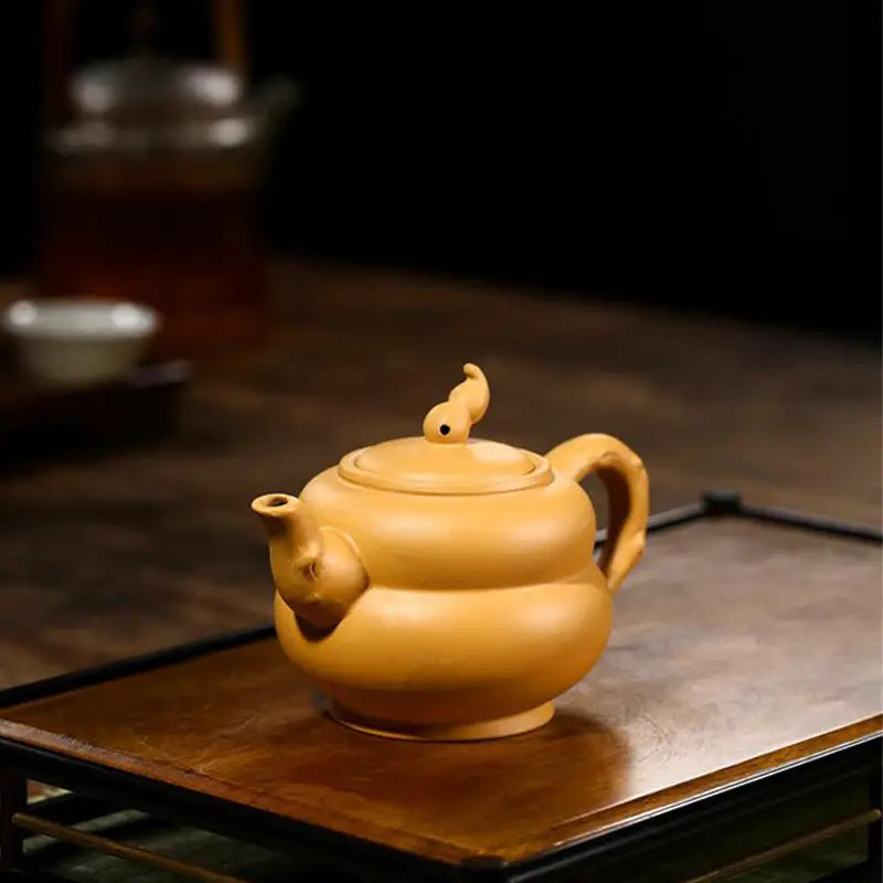 Earthenware teapot with stylized spout and handle in Golden Gourd, perfect for Gongfu tea brewing
