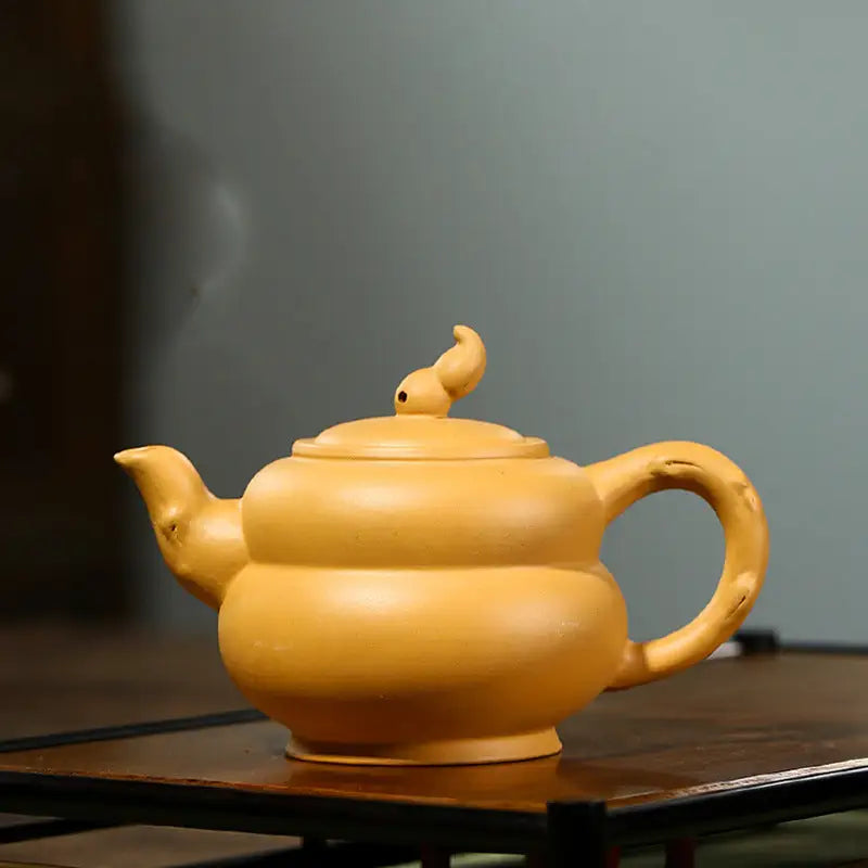 Yellow ceramic teapot from Golden Gourd, ideal for Gongfu tea brewing with Yixing Zisha and Duanni clay
