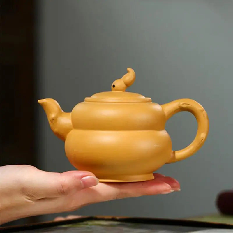 Yellow ceramic teapot from Golden Gourd, ideal for Gongfu Tea brewing in Yixing Zisha and Duanni clay