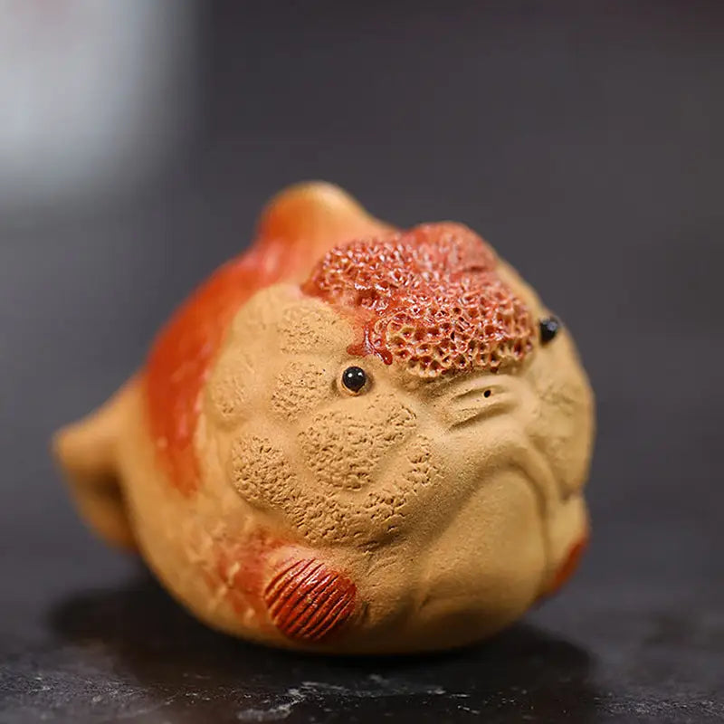 Ceramic lionhead goldfish tea pet figure with textured surface for Golden Guardian product