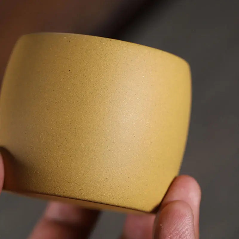 Smooth mustard-yellow ceramic cup from Golden Harmony made with yellow Duanni clay and Yixing Zisha