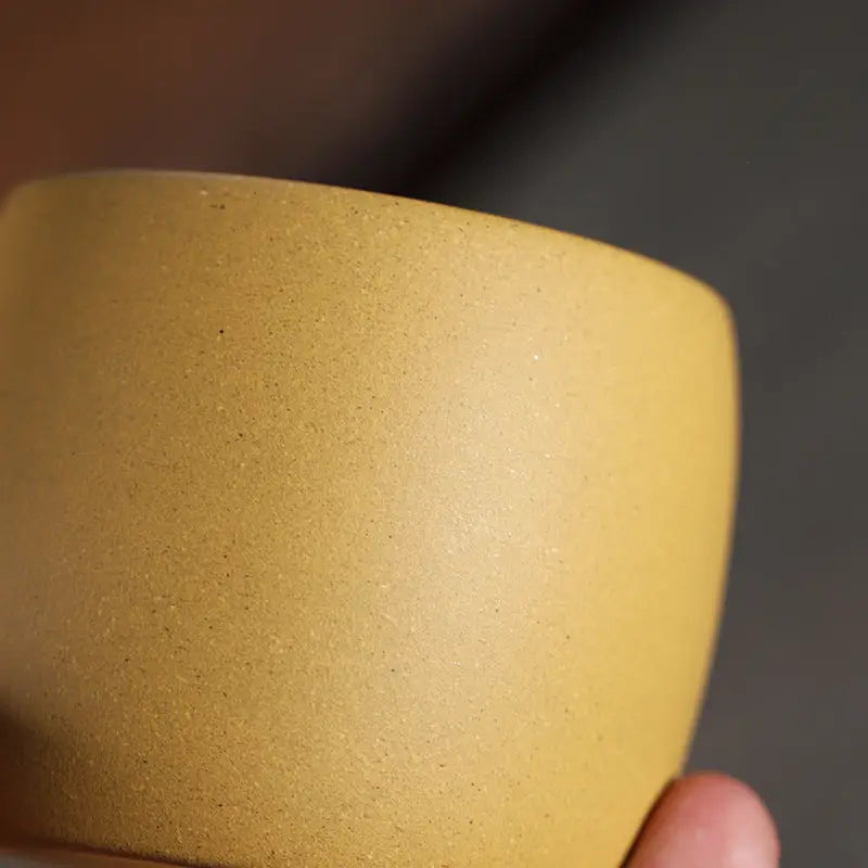 Smooth mustard-yellow ceramic cup from Golden Harmony made with yellow Duanni Clay and Yixing Zisha