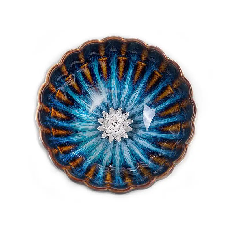 Decorative blue and gold bowl with flower accent from Golden Peacock Tenmoku Jian Zhan Tea collection
