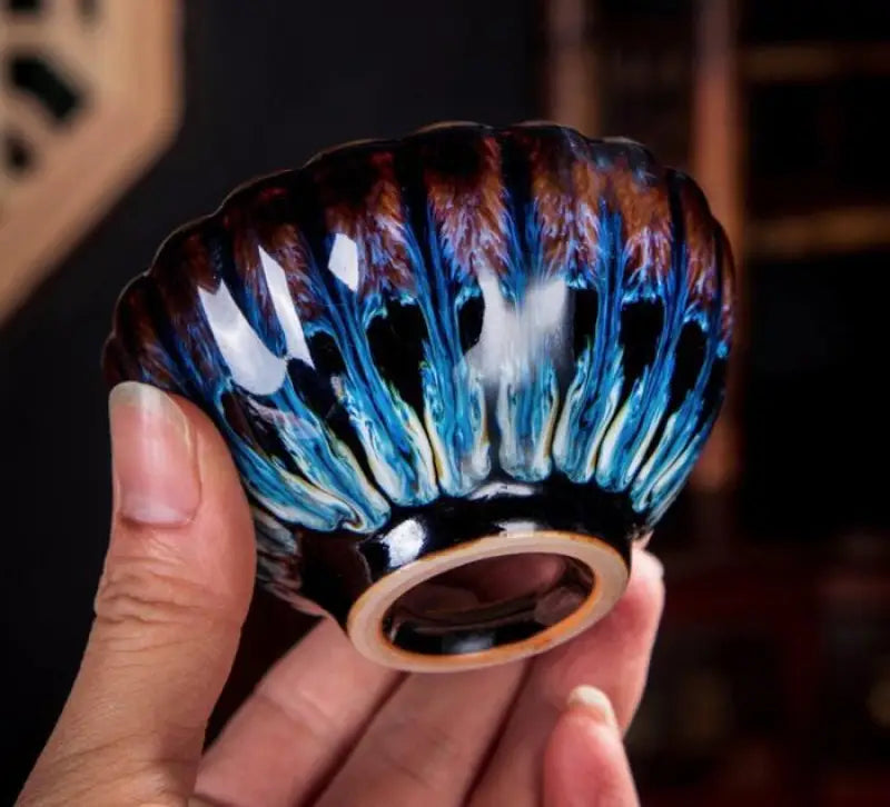 Iridescent ceramic teacup from Golden Peacock Tenmoku Jian Zhan Tea Cup collection