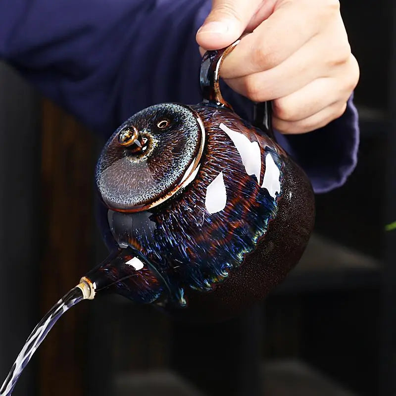 Ceramic Golden Peacock Jian Zhan Teapot with oil-spot glaze pouring water