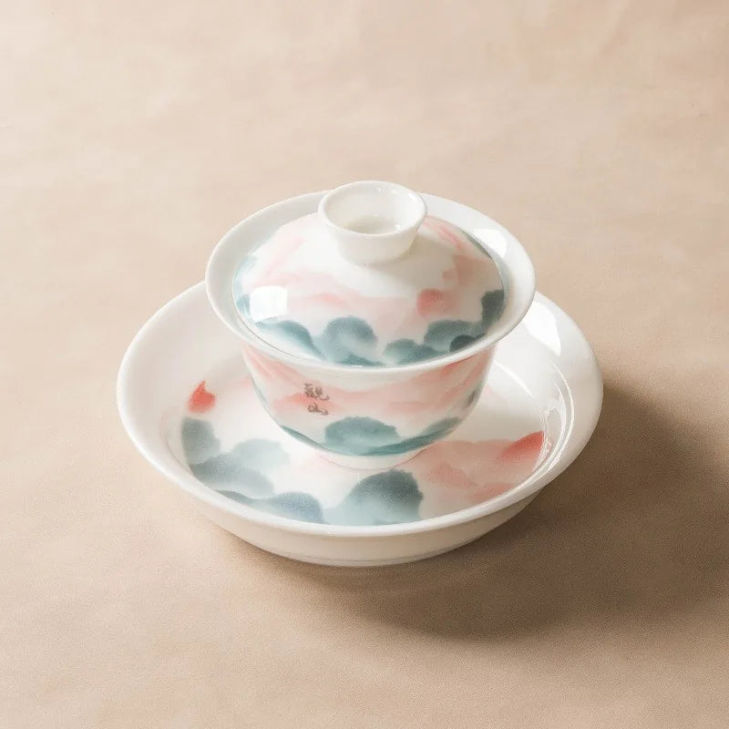 Jade-white gaiwan with pink and teal famille rose mountain landscape – photo 1